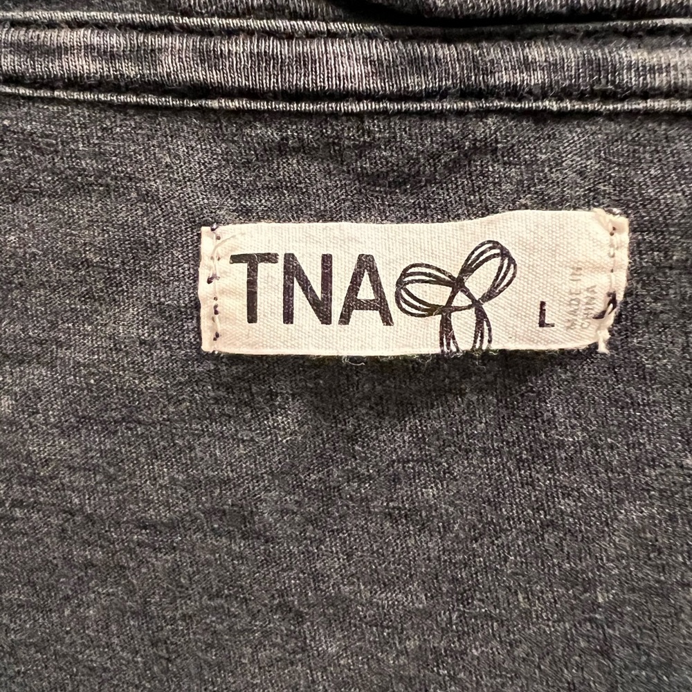3 T-shirts. 2 gray, one white.
